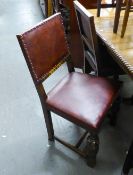 A PAIR OF OAK REPRODUCTION DINING CHAIRS, HAVING PAD BACK AN SEAT WITH STUD DETAILS ON CUP AND COVER