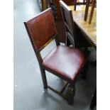 A PAIR OF OAK REPRODUCTION DINING CHAIRS, HAVING PAD BACK AN SEAT WITH STUD DETAILS ON CUP AND COVER