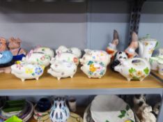 A GROUP OF PORCELAIN PIG PIGGY BANKS AND A PAIR OF SPANISH STONEWARE DUCKS