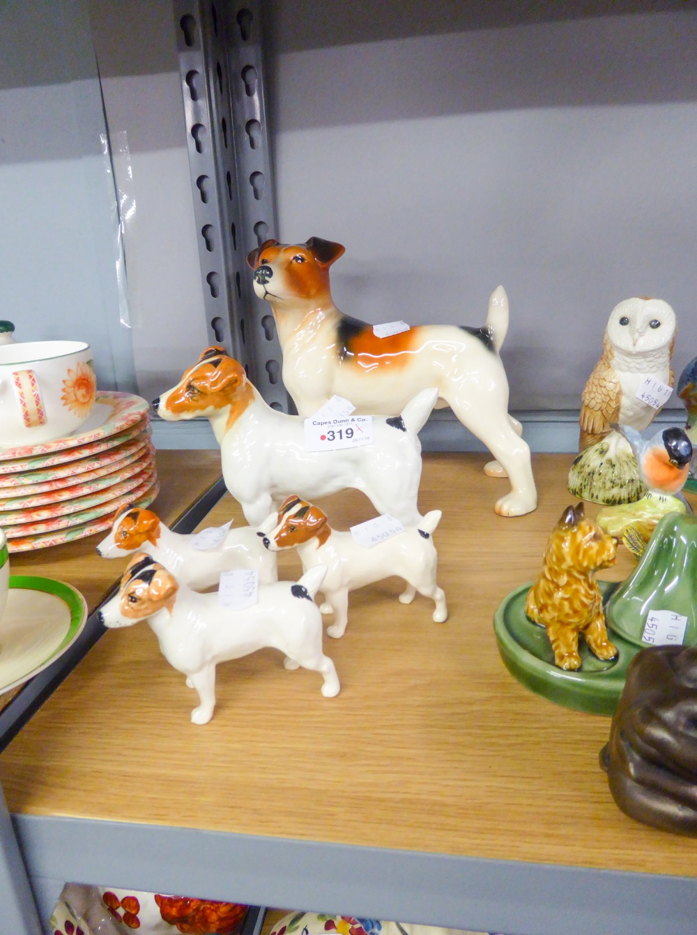 A SET OF FOUR BESWICK JACK RUSSELL FIGURINES AND A MELBA EXAMPLE (5)