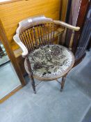 EDWARDIAN MAHOGANY ARMCHAIR WITH CARVED BACK RAIL AND SCROLL ARMS, SPINDLE BACK OVER PAD SEAT, ON