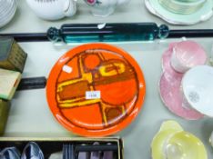 A VICTORIAN GLASS ROLLING PIN AND POOLE POTTERY PLATE WITH ORANGE GROUND AND ABSTRACT DECORATION