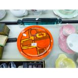 A VICTORIAN GLASS ROLLING PIN AND POOLE POTTERY PLATE WITH ORANGE GROUND AND ABSTRACT DECORATION