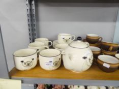 A SET OF SIX ARTHUR WOOD MODERN TEA CUPS AND SAUCERS WITH SHEEP AND EWE DECORATION AND A TEAPOT