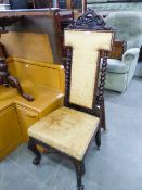 VICTORIAN CARVED WALNUT PRIE DIEU CHAIR WITH UPHOLSTERED HIGH BACK AND STUFFED OVER SEAT, COVERED IN