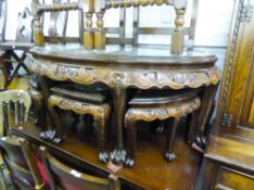 AN EARLY 20TH CENTURY LACQUERED ORIENTAL HARDWOOD HIGH RELIEF CARVED NEST OF SEVEN TABLES, EACH WITH