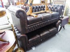 A ROUND BACKED CHESTERFIELD THREE SEATER SETTEE, BUTTON UPHOLSTERED IN DARK BROWN HIDE