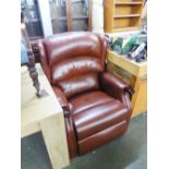 A LIGHT BROWN LEATHER RECLINING ARMCHAIR
