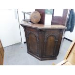 A JUST PRE-WAR OR POST-WAR WARING AND GILLOW CARVED OAK DRINKS BAR AND THREE BAR STOOLS