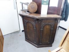 A JUST PRE-WAR OR POST-WAR WARING AND GILLOW CARVED OAK DRINKS BAR AND THREE BAR STOOLS