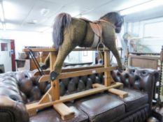 PLATFORM ROCKING HORSE, COVERED IN BROWN FUR FABRIC WITH GLASS EYES, WITH BROWN LEATHER SADDLE AND