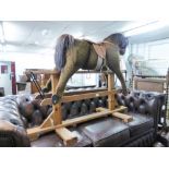 PLATFORM ROCKING HORSE, COVERED IN BROWN FUR FABRIC WITH GLASS EYES, WITH BROWN LEATHER SADDLE AND