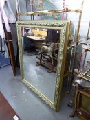 A MODERN GILT FRAMED WALL MIRROR