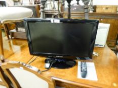 A 22" SAMSUNG FLATSCREEN TV AND REMOTE CONTROL