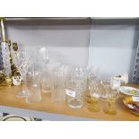 A QUANTITY OF CUT GLASS DRINKING GLASSES, SOME WITH ETCHED DETAIL