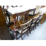 A VICTORIAN MAHOGANY EXTENDING DINING TABLE, WITH TWO LEAVES, ON TURNED FLUTED SUPPORTS AND CASTORS