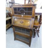 A 1930's OAK BUREAU BOOKCASE, WITH LEADED GLAZED DOORS AND A FALL FRONT SECTION