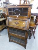 A 1930's OAK BUREAU BOOKCASE, WITH LEADED GLAZED DOORS AND A FALL FRONT SECTION