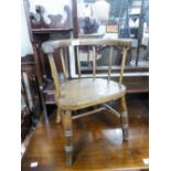 A CHILD'S ANTIQUE ELM TUB SHAPED CHAIR WITH PANEL SEAT