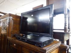 A 32" PANSONIC FLATSCREEN TV AND A PANASONIC DVD PLAYER AND REMOTES