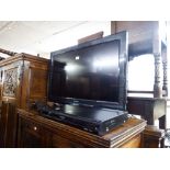 A 32" PANSONIC FLATSCREEN TV AND A PANASONIC DVD PLAYER AND REMOTES