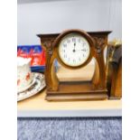 SWISS WALNUTWOOD ART DECO MANTEL CLOCK, THE DIAL RAISED ON FLORAL STEM SUPPORTS ON SOLID BASE