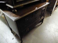 CARVED MAHOGANY DRESSING CHEST WITH SWING MIRROR, TWO SHORT AND TWO LONG DRAWERS AND A CUPBOARD WITH