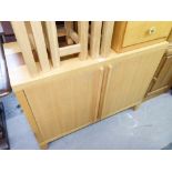 A STYLISH MODERN LIGHT OAK TWO DOOR SIDEBOARD, 3'4" WIDE