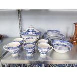 A GROUP OF BLUE AND WHITE 'OLD WILLOW' PATTERN DINNER AND TEA SERVICE FOR EIGHT PERSONS, WITH TUREEN