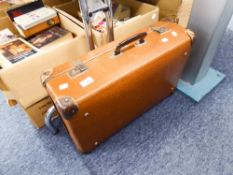 A BROWN LEATHER SUITCASE