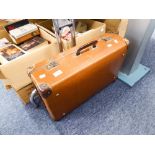 A BROWN LEATHER SUITCASE