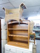 A MODERN BOOKCASE HAVING TWO SHELVES, WICKER ARMCHAIR ON WROUGHT IRON SUPPORTS AND A MODERN CREAM