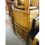 A 1930's FADED WALNUTWOOD BEDROOM CABINET WITH THREE DRAWER BENEATH