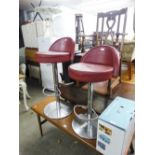 A PAIR OF ADJUSTABLE MODERN BAR STOOLS HAVING BERRY HID PAD SEAT AND SHORT BACK ON CHROME STANDS (2)