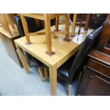 A MODERN LIGHT OAK DINING TABLE AND FOUR HIGH BACK CHARS, WITH LEATHER UPHOLSTERY (5)