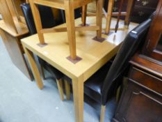 A MODERN LIGHT OAK DINING TABLE AND FOUR HIGH BACK CHARS, WITH LEATHER UPHOLSTERY (5)