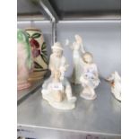 LLADRO FIGURINE OF YOUNG GIRL PLAYING WITH HER TEDDY; NAO FIGURE GROUP OF A YOUNG MAN TEACHING HIS
