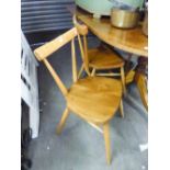 A PAIR OF POLISHED WOOD SINGLE CHAIRS WITH HOOP BACKS AND TWO OTHERS AND A CIRCULAR DINING TABLE (5)