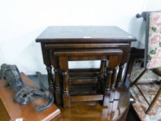 A JAYCEE REPRODUCTION OAK NEST OF THREE TABLES, SOLID TOPS ON TURNED SUPPORTS