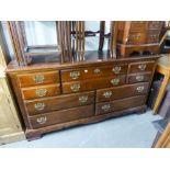 A REPRODUCTION MAHOGANY LARGE CHEST OF DRAWERS/SIDEBOARD, HAVING FOUR SHORT EITHER SIDE OF TWO