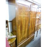 AN EDWARDIAN INLAID MAHOGANY TWO DOOR WARDROBE WITH BASAL DRAWERS