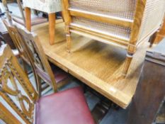 A LARGE OAK DRAW LEAF DINING TABLE, WITH TURNED CARVED COLUMNS TO EACH END AND A SET OF SIX (4 +