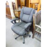 AN EXECUTIVE REVOLVING OFFICE ARMCHAIR, IN BLACK TWEED, ON FIVE SPUR BASE