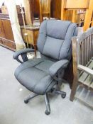 AN EXECUTIVE REVOLVING OFFICE ARMCHAIR, IN BLACK TWEED, ON FIVE SPUR BASE