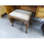 A MAHOGANY OBLONG DRESSING STOOL WITH UPHOLSTERED DROP-IN SEAT, ON FOUR SHELL CARVED CABRIOLE