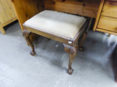 A MAHOGANY OBLONG DRESSING STOOL WITH UPHOLSTERED DROP-IN SEAT, ON FOUR SHELL CARVED CABRIOLE