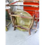 A BRASS TOPPED CIRCULAR COFFEE TABLE ON FOLDING FRAME