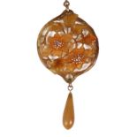An attractive Art Nouveau carved and dyed horn floral pendant