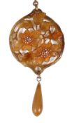 An attractive Art Nouveau carved and dyed horn floral pendant