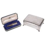 A contemporary silver trinket box and a novelty silver champagne bottle cigar piercer